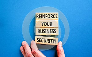 Reinforce your business security symbol. Concept word Reinforce your business security on blocks. Beautiful blue table blue