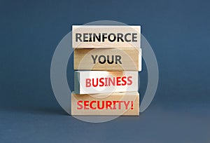 Reinforce your business security symbol. Concept word Reinforce your business security on blocks. Beautiful grey table grey