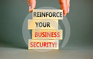 Reinforce your business security symbol. Concept word Reinforce your business security on blocks. Beautiful grey table grey