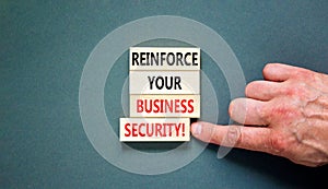 Reinforce your business security symbol. Concept word Reinforce your business security on blocks. Beautiful grey table grey