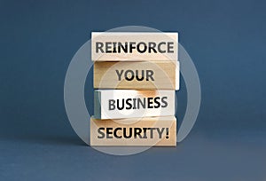 Reinforce your business security symbol. Concept word Reinforce your business security on blocks. Beautiful grey table grey