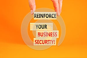 Reinforce your business security symbol. Concept word Reinforce your business security on blocks. Beautiful orange background.