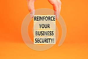 Reinforce your business security symbol. Concept word Reinforce your business security on blocks. Beautiful orange background.