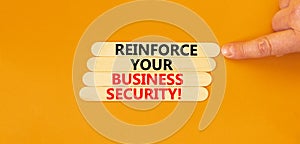 Reinforce your business security symbol. Concept word Reinforce your business security on sticks. Beautiful orange background.