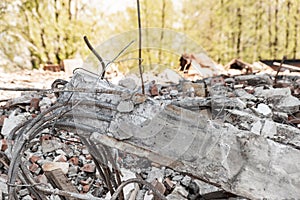 Reinforced armature on background of dismantled building