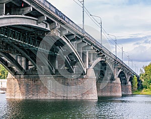 Reinforced concrete bridge across the river. Cityscape