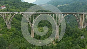 Reinforced concrete bridge over Tara river in mountains. Djurdjevic Bridge