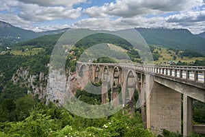 Reinforced concrete bridge over Tara river in mountains. Djurdjevic Bridge