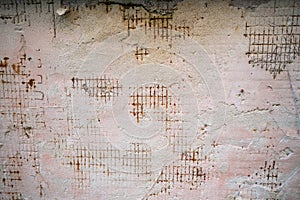 Reinforced concrete with damaged and rusty steel reinforcement. Old distressed wall texture background, steel bars and