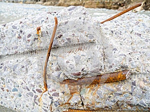 Reinforced concrete. Destroyed building material. Rusty iron. Reinforced concrete wall. Construction garbage. consequences of