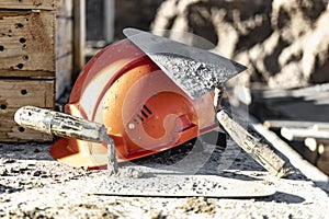 Reinforced concrete foundation formwork with orange construction helmet. Construction of the foundation of a new house,