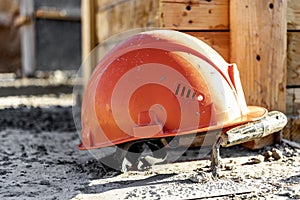 Reinforced concrete foundation formwork with orange construction helmet. Construction of the foundation of a new house,