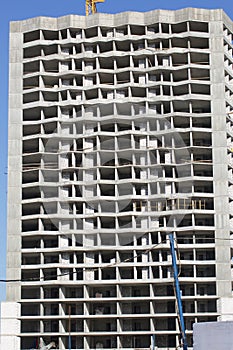 Reinforced concrete house frame. Modern high-rise buildings made of concrete and glass. Construction site. The final stage of