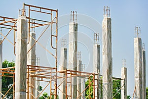 Reinforced concrete piles of the new house building with clear plastic wrap for keeping the temperature to keep the pole strong