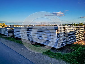 Reinforced concrete slabs stacked next to a newly built residential house