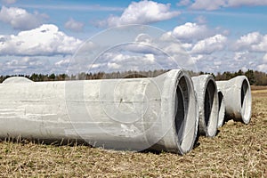Reinforced concrete storm sewer pipes of large diameter stacked at a construction site. Sewer Large diameter pipes. Wastewater
