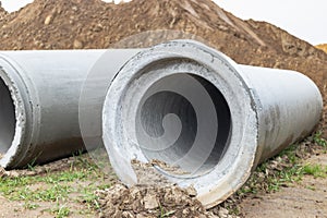 Reinforced concrete storm sewer pipes of large diameter stacked at a construction site. Sewer Large diameter pipes. Wastewater