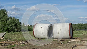 Reinforced concrete storm sewer pipes of large diameter stacked at a construction site. Sewer Large diameter pipes