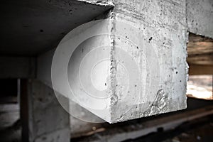 Reinforced concrete structure of columns, beams and floors of a building under construction. Close-up on a beam