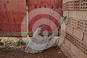 Reinforced concrete structure thrown on the floor in a building renovation to the ladop of blocks and wooden plank wall at constru