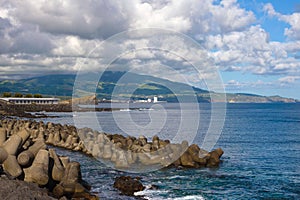 Reinforced concrete tetrapods by the sea in the city of Ponta Delgada protect the coast from waves.