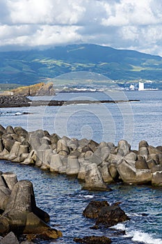 Reinforced concrete tetrapods by the sea in the city of Ponta Delgada protect the coast from waves.