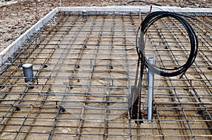 Reinforced Foundation for concrete pouring and preparation for communications in the construction of a house on a plot of land