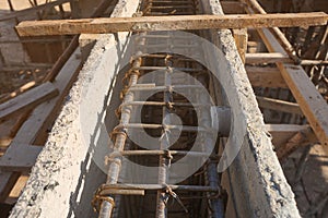 Reinforced steel beams with single concrete spacers round type in plastic formwork for pouring concrete beams .