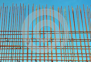 Reinforcement steel bars against blue sky background at construction site