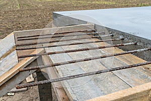 Reinforcing bars sticking out of reinforced concrete slab.