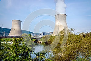 The cooling towers of a nuclear power plant dominate the landscape. photo