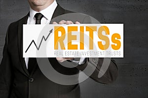 REITs sign is held by businessman
