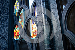 Colorful stained glass window seen through a fence in Recoleta Cemetery in Argentina photo