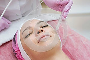 Woman getting face peeling procedure in a beauty SPA salon.  Rejuvenating facial gas liquid treatment