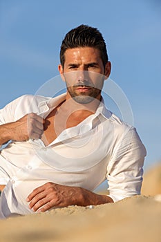 Relalaxed man seated on the sand