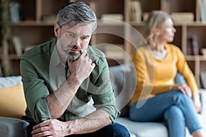 Relationship Crisis. Middle Aged Couple Sitting Offended On Couch After Argue