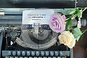 Relationship inspirational quote - Communication is good, but understanding is everything. Message on white paper with roses.