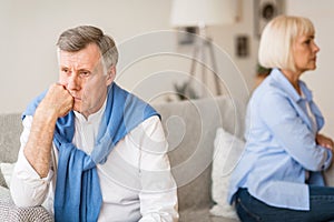 Relationship problems. Senior couple after argument sitting on sofa