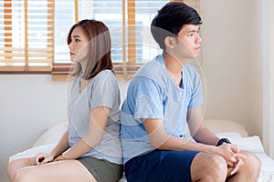 Relationship of young asian couple having problem on bed in the bedroom at home, family having conflict argument with unhappy