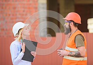 Relationships construction client and participant building industry. Discuss progress plan. Woman engineer and bearded