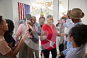 Relatives arriving at a three generation African American  family Independence Day house party,close up