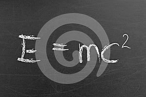 Relativity equation E mc2 handwritten by chalk on a university blackboard