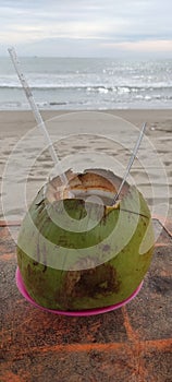 Relax on the beach while enjoying drinking young coconut