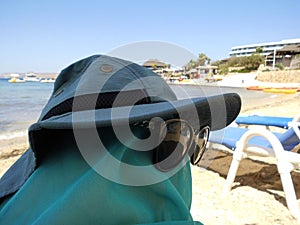 Relax on the beach. Legs dressed up with accessories.  Humor. Triq Ir-Ramla, Il-Mellieha, Malta