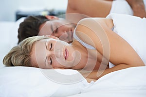 Relax, bed or couple sleeping for fatigue, peace or dreaming together in marriage on holiday vacation. Wellness, house