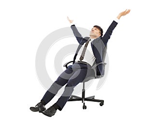 Relax businessman sitting on a chair and raise hands