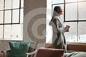 Relax, coffee and woman looking out window from her home, thinking and daydreaming on a quiet morning. Daydream, tea and