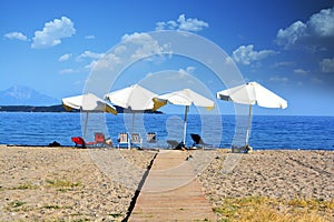 Relax concept, empty beach with parasols and chairs