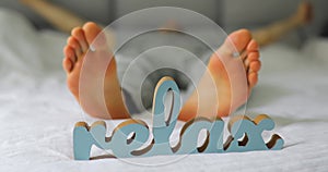 Relax concept. Male legs lying on a bed.