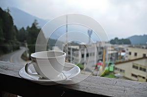 Relax with a cup of hot coffee in misty morning in a mountain in